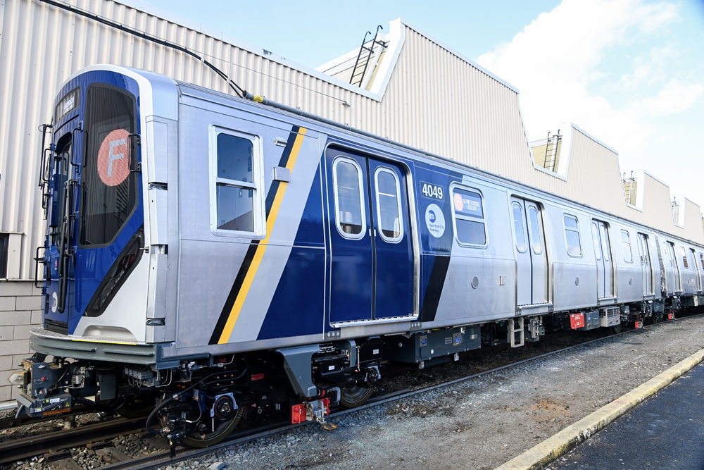 Exterior of subway car with blue diagonal striping at one end