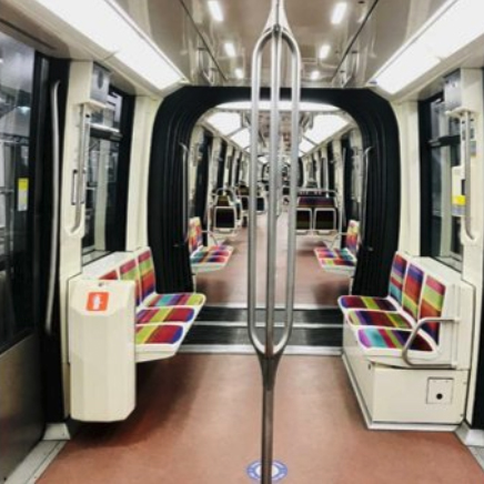 Interior of subway car with open space, instead of a wall, between cars