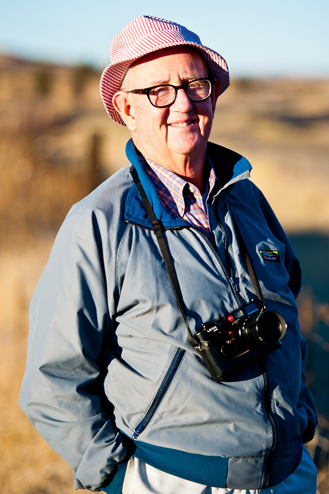 Man with camera around neck in western landscape