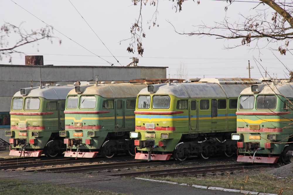 Four tracks of stored boxcab-style diesel locomotives