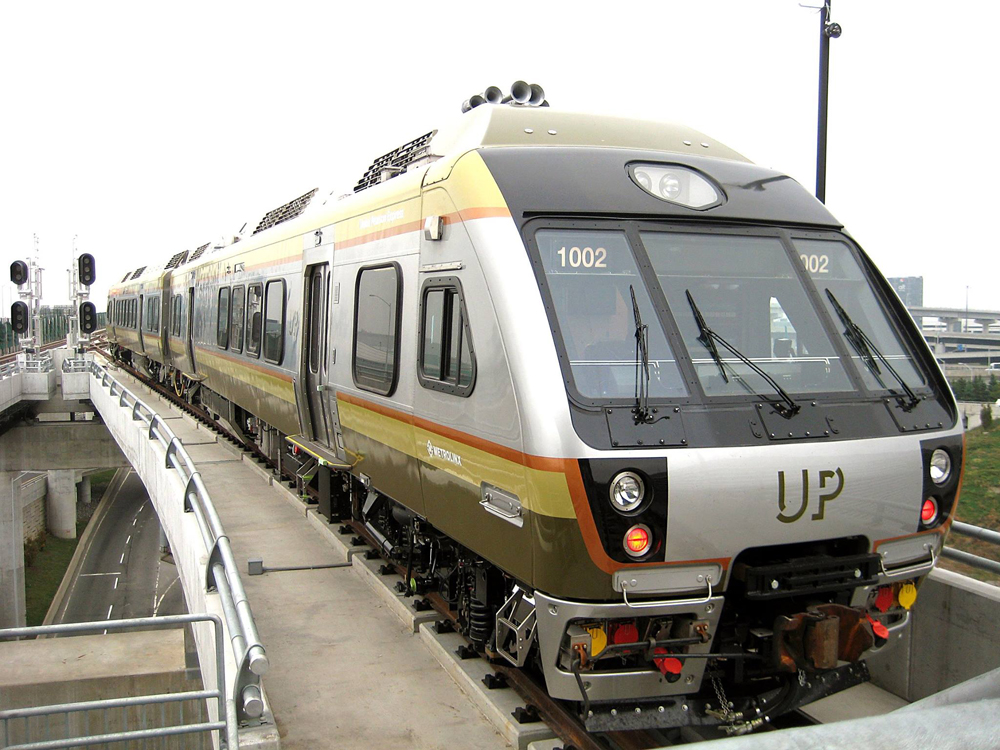 Silver two-car DMU trainset on bridge