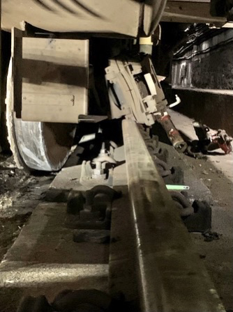 Close-up of derailed axle on rapid-transit railcar