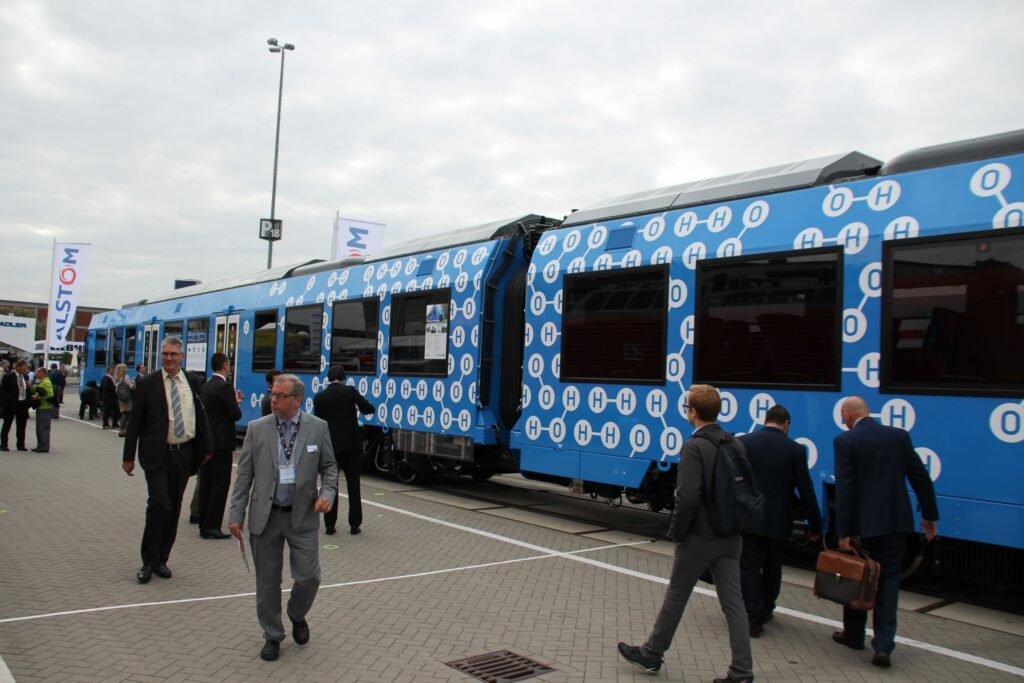 Blue and white passenger train with people