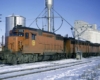 Red-and-black diesel-powered Kansas City Southern locomotives in snow