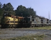 Three quarter view of diesel-powered Kansas City Southern locomotives in yard