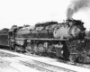 Three quarter front view of steam locomotive in yard