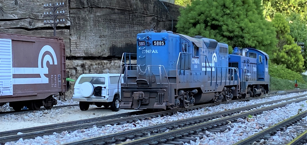 blue model locomotive on garden railway