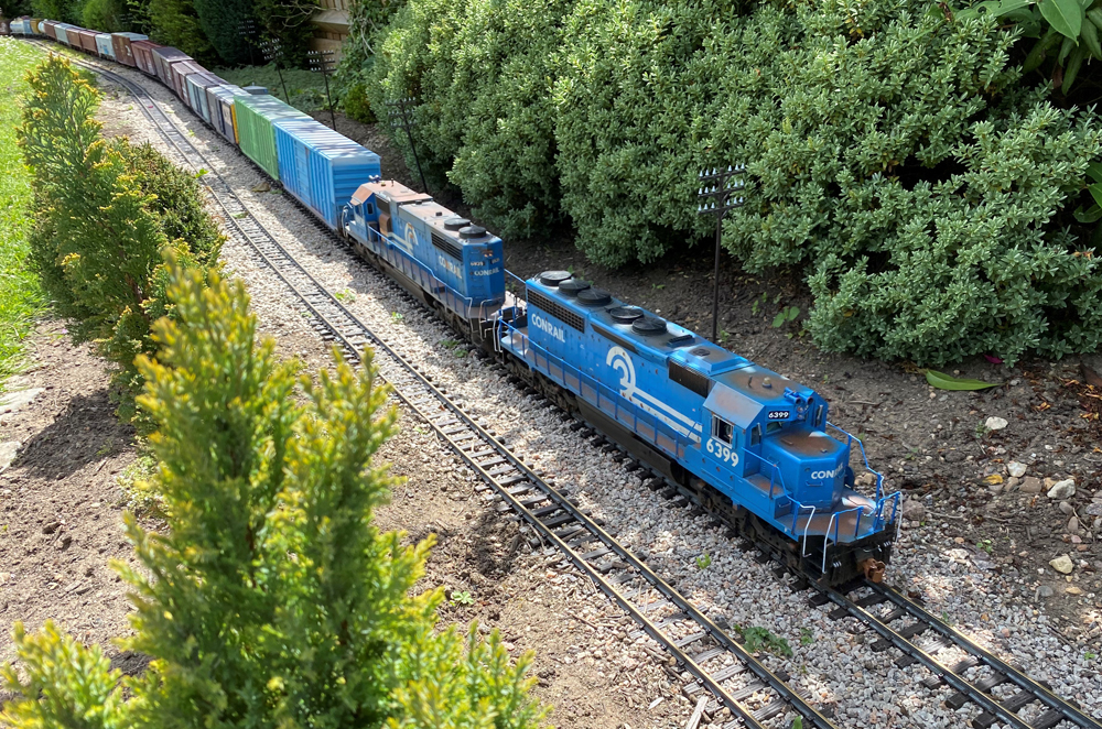 blue model train on a garden railway