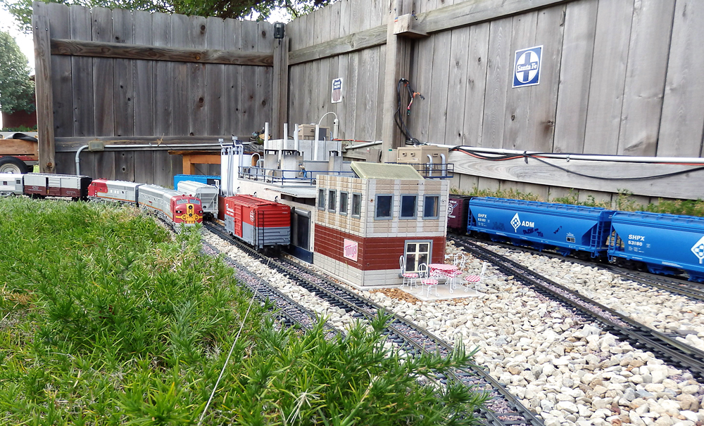 train with blue cars on garden railroad
