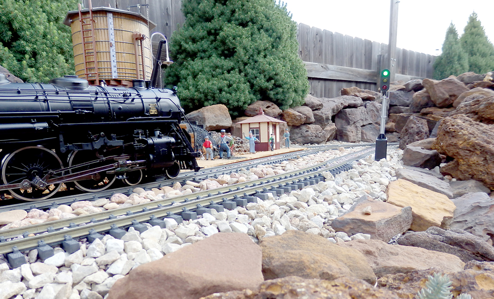 low shot of model steam engine on garden railway