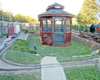 gazebo in the middle of a backyard garden railway