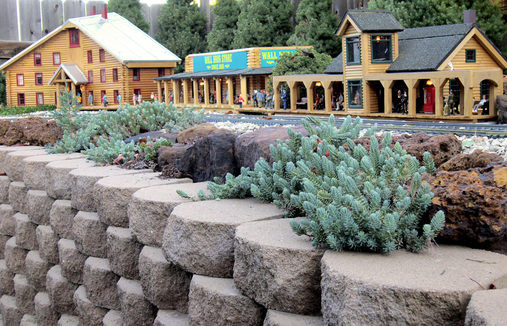 ow angle shot of three trackside structures on garden railway