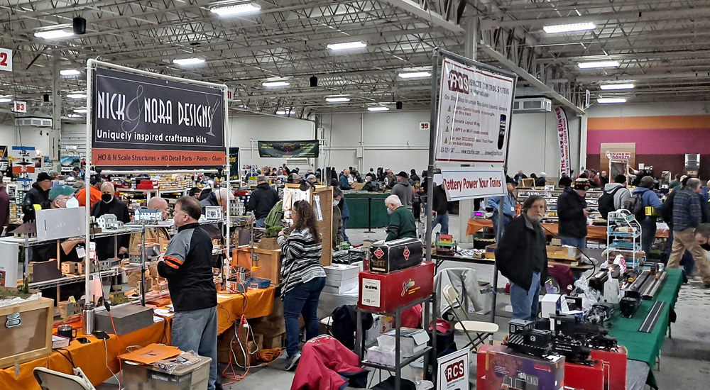 People browse crowded vendor booths in an exhibition hall