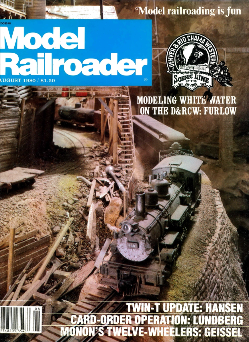 Malcolm Furlow's waterfall modeling technique: Model Railroader magazine cover with blue and white logo and image of steam locomotive pulling a train around a mountain curve.