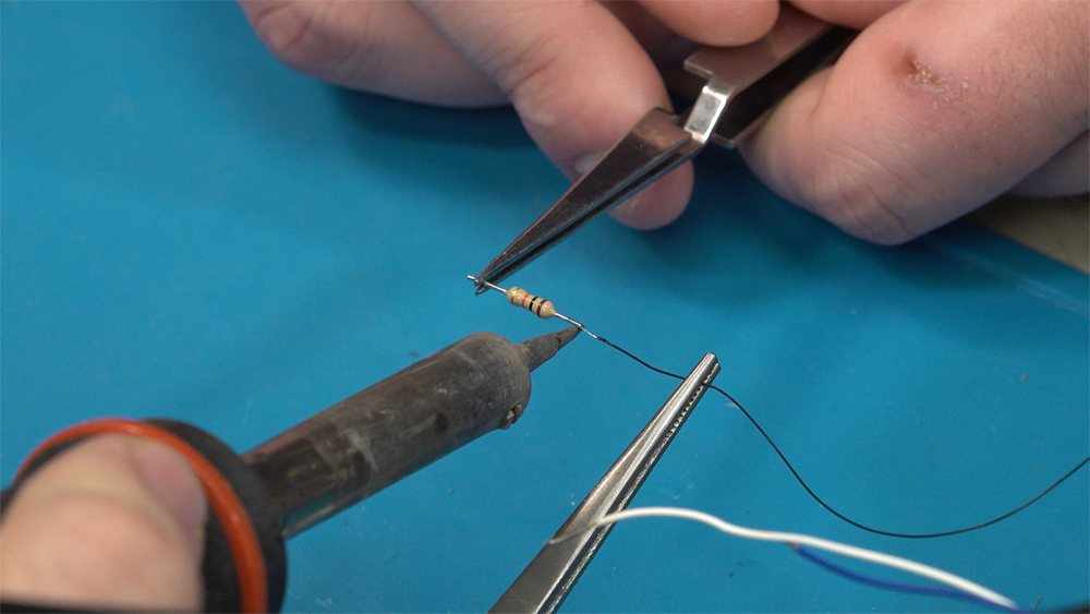 A resistor is soldered to a black wire