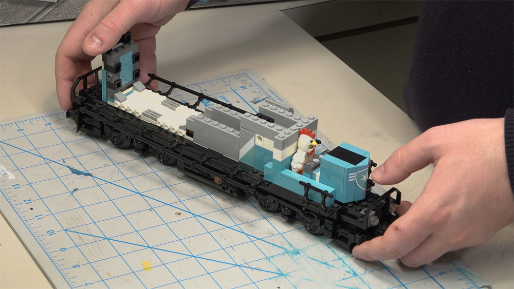 The Lego locomotive is stripped of its cab and long hood