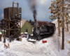 Color photo of steam engine on model railroad.