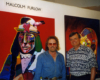 Photo of two men in front of a painting.