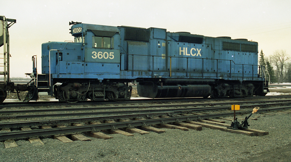 Color photo of weathered blue diesel with white graphics.
