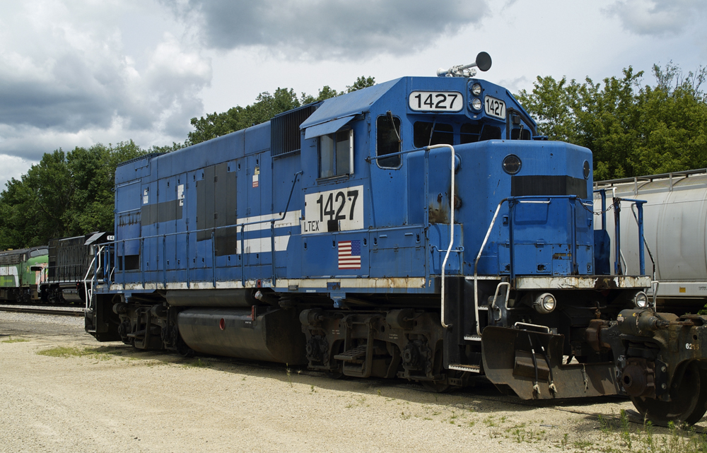 Color photo of blue and white locomotive with black patches.