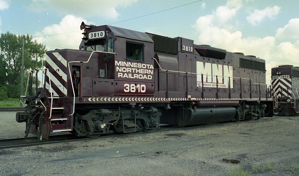 Color photo of maroon and white diesel locomotive.