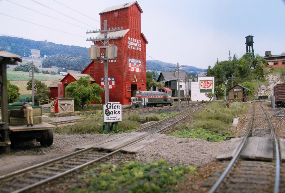 An image of a model layout with a large red grain elevator