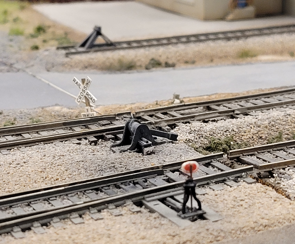 An image showing model rail tracks, switch stands and switch targets