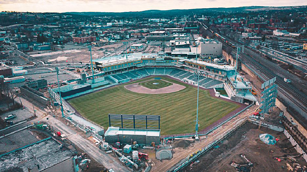 Blue-green colored baseball stadium in city setting. High iron baseball — AAA minor league stadiums.