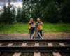 two men in vest trackside with Imax camera