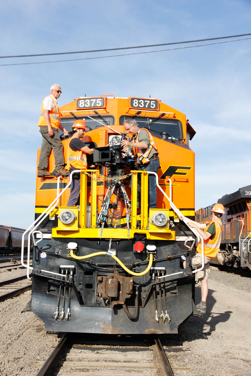 men on front of diesel with camera mounted