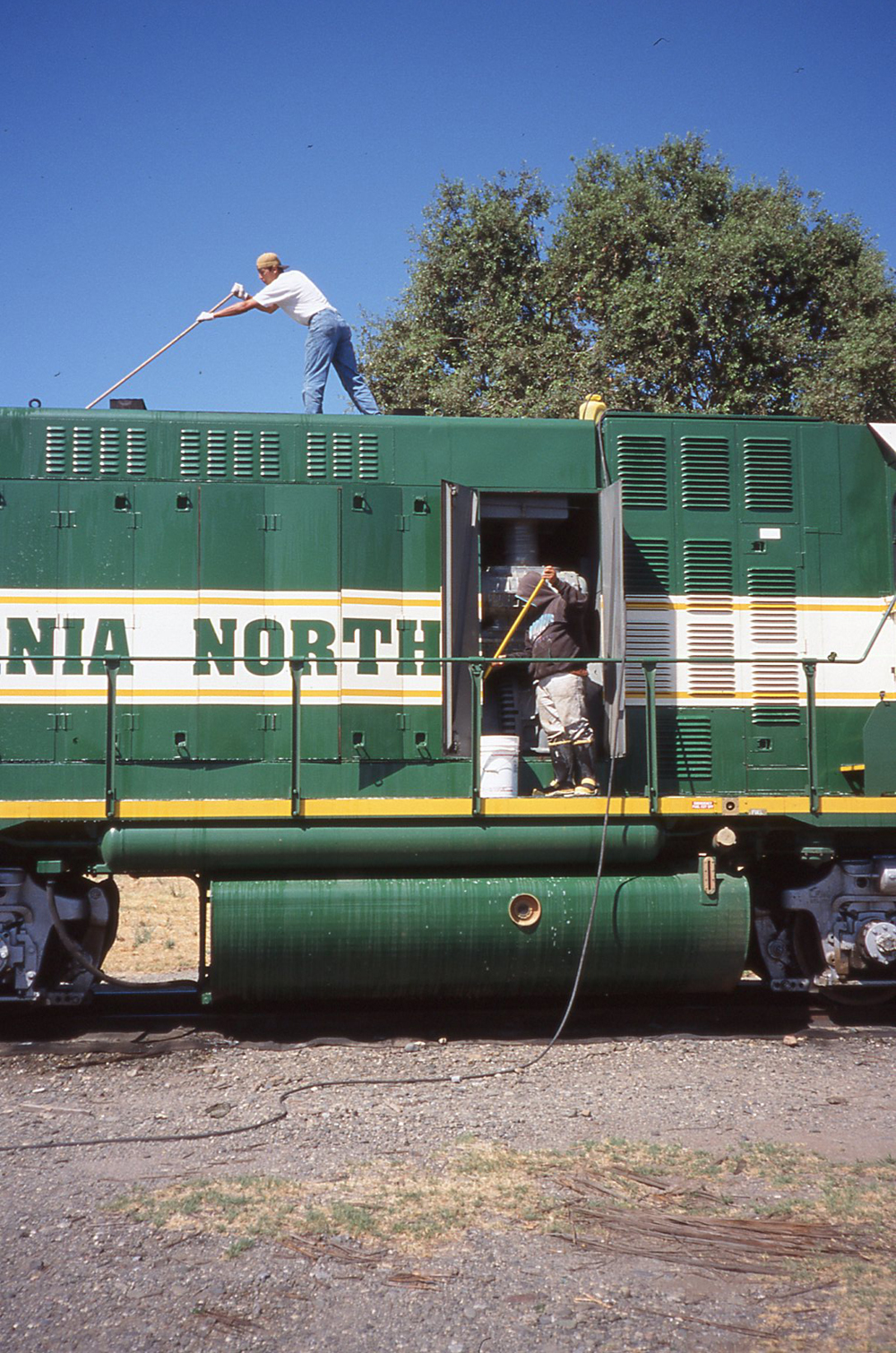 guys cleaning locomotive prime mover