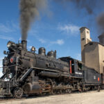 black locomotive No. 93 with gray smoke