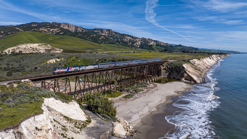 Passenger train on trestle near Pacific Ocean