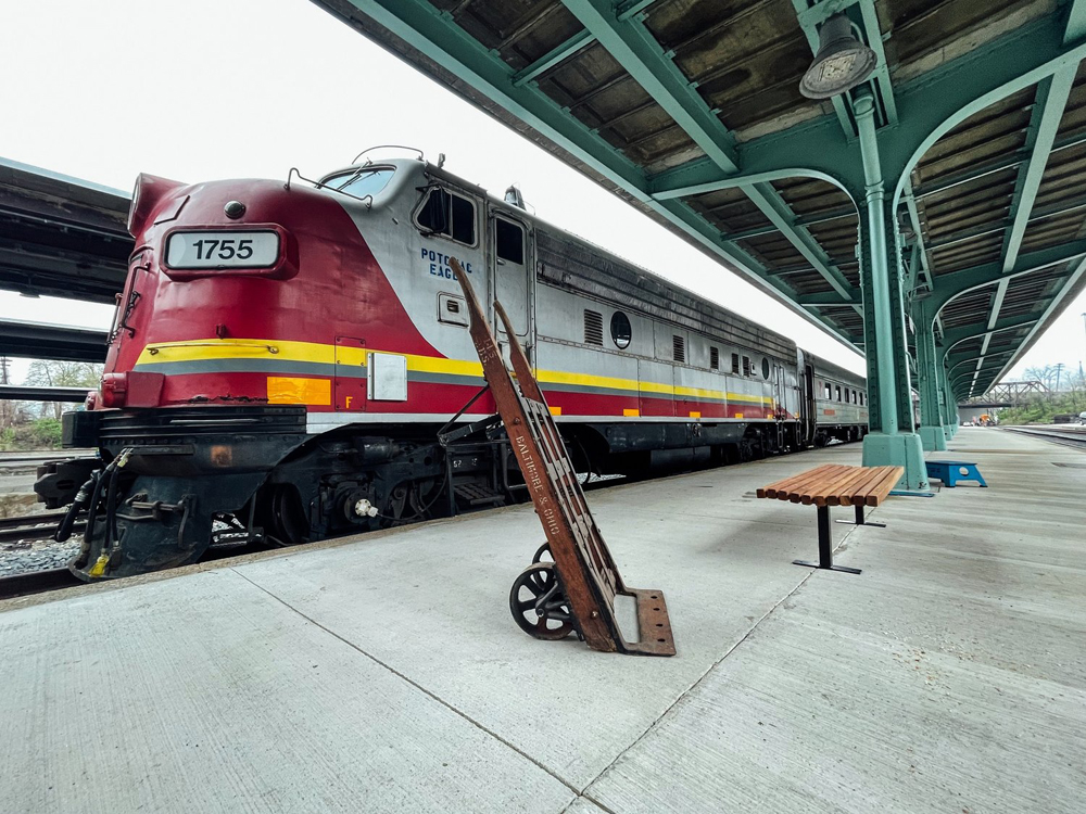 F unit locomotive and passenger cars at station platform