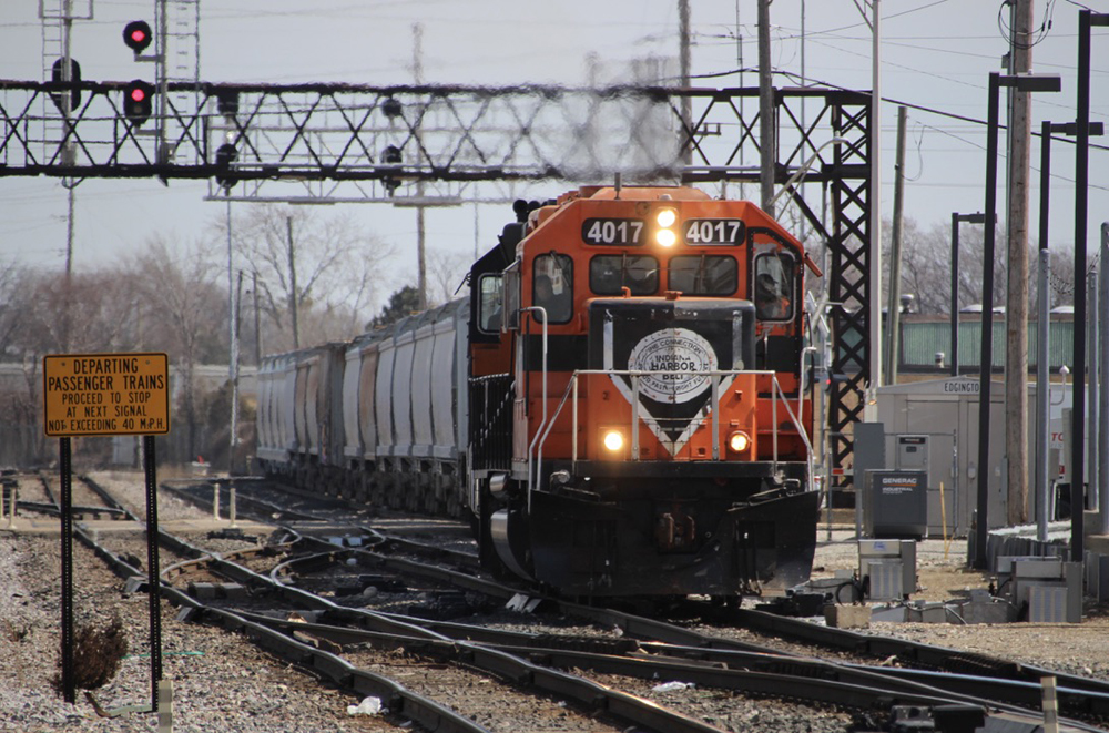 Orange and black locomotive on freight train