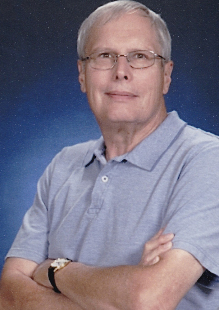 Man with white hair and glasses
