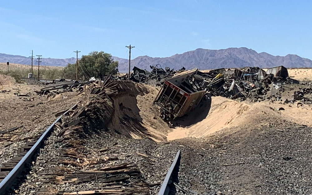 Badly damaged railcars and track at derailment site