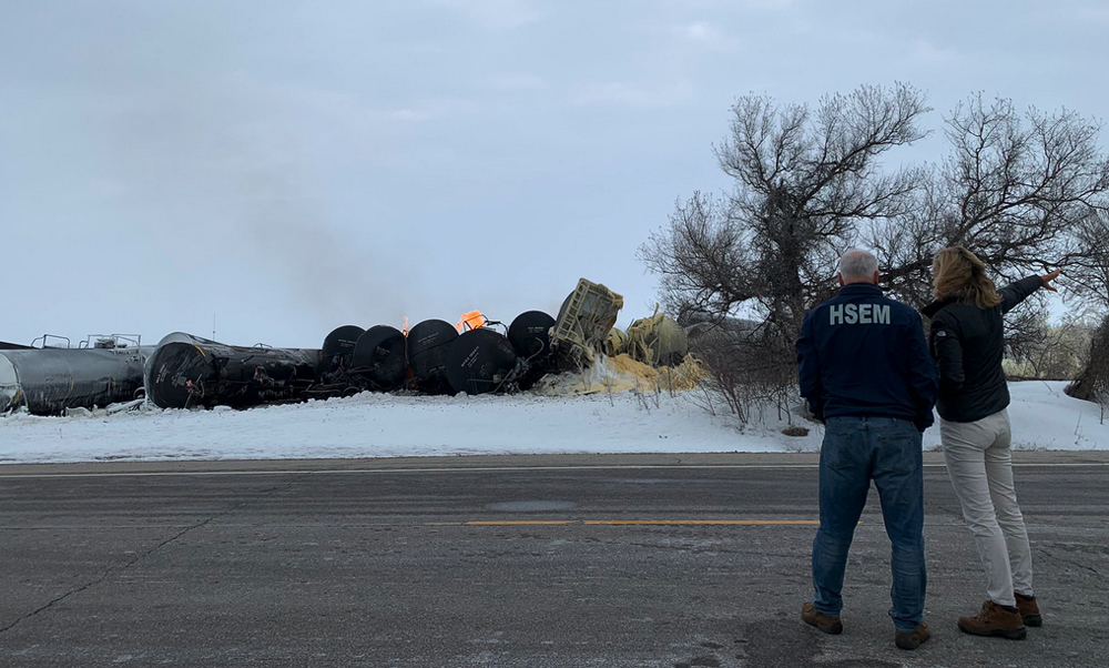 Two people looking at derailment damage