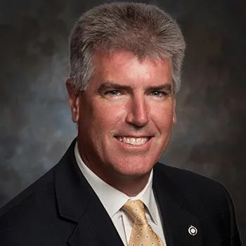 Head shot of man in coat and tie