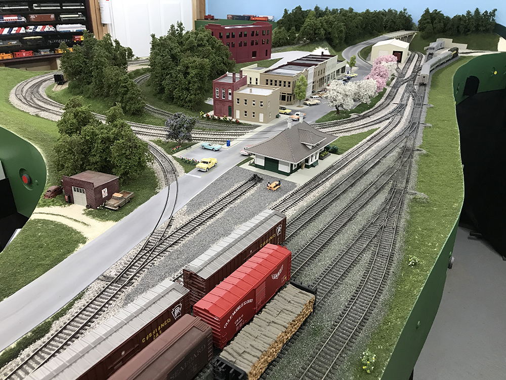 Carolina Sandhills Lines layout: Model train layout freight yard, including gray track and brown, red, and silver freight cars