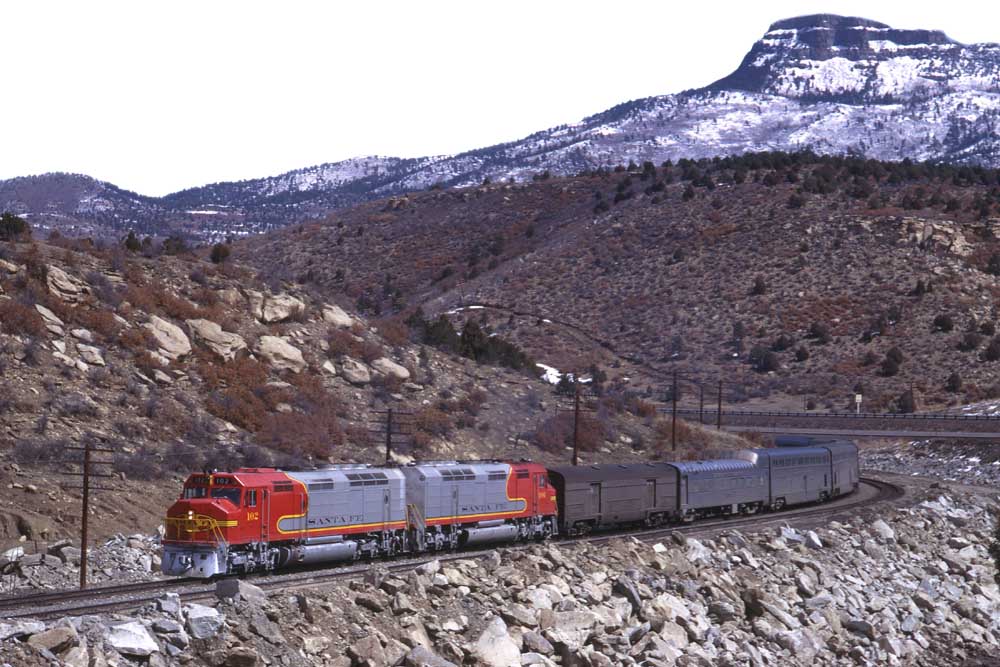 Santa Fe El Capitan train rounds curve in mountains