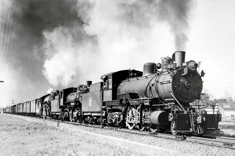 Three steam locomotives on freight train