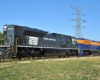 Recreated Penn Central diesel locomotive with blue-and-orange locomotive under power line