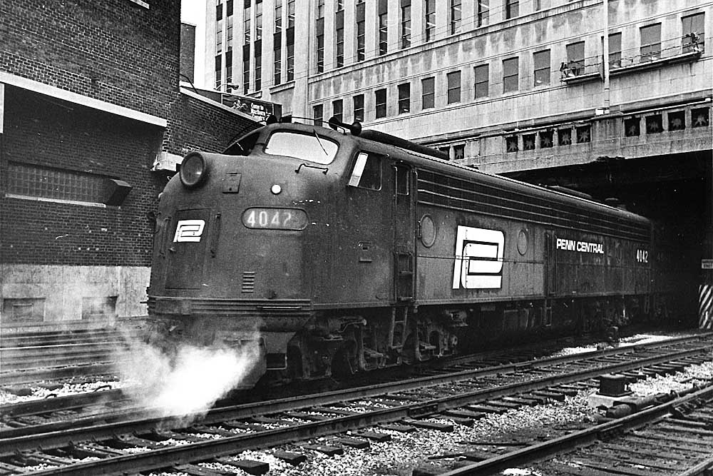 Streamlined diesel Penn Central locomotives under building