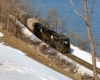 Two Penn Central locomotives with freight train on shoreline