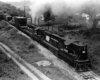 Two Penn Central locomotives pushing on a freight train