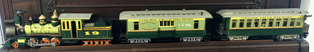 green model locomotive with two cars