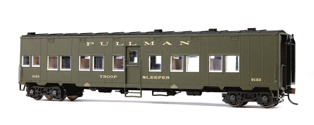 A military-green HO scale troop sleeper car on a white background