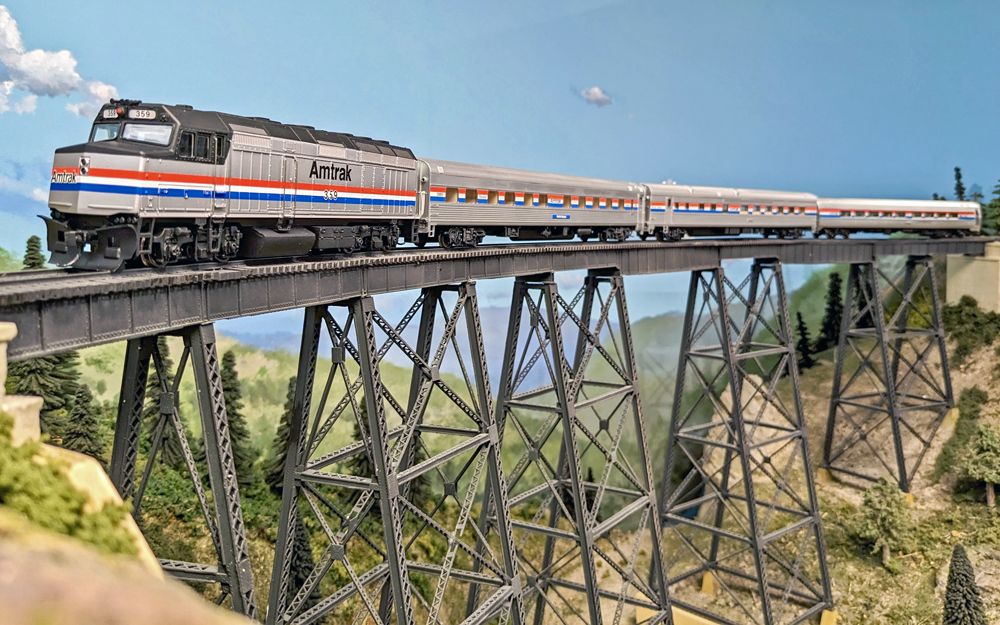 A model passenger train on a bridge