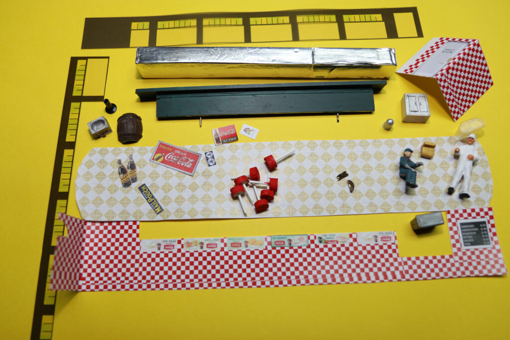 Printed and crafted colorful details used for making an interior for a model diner.